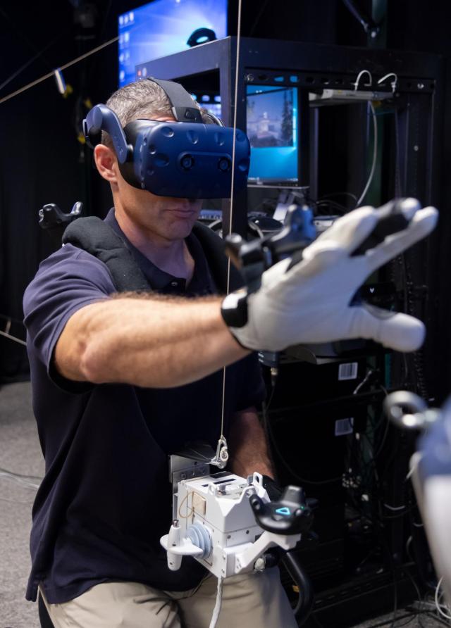 Mike Hopkins practices spacewalking in the Virtual Reality Lab at Johnson Space Center in Houston