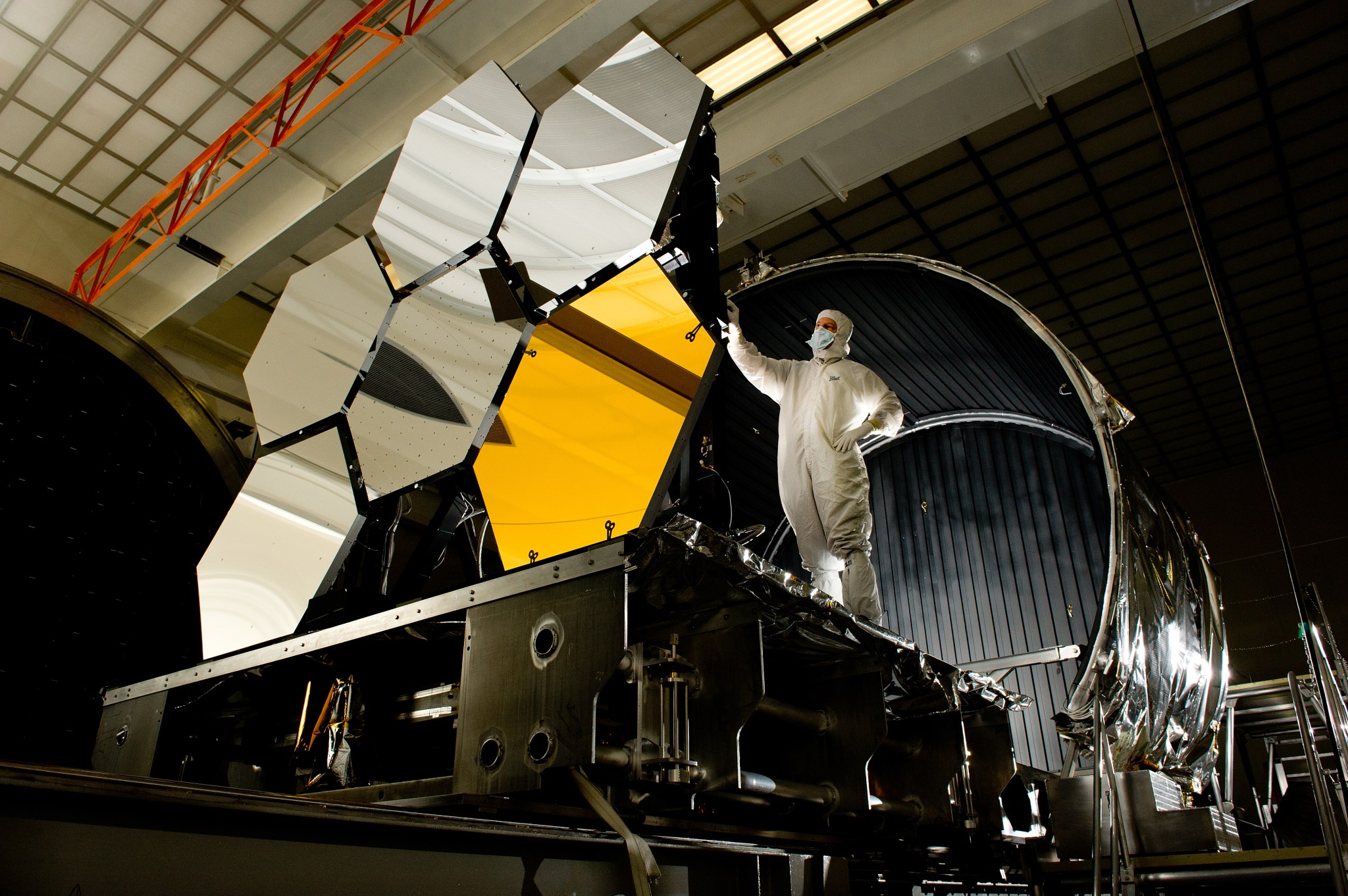 Ball Aerospace lead optical test engineer Dave Chaney inspects six primary mirror segments, critical elements of the James Webb Space Telescope, prior to cryogenic testing in the X-ray & Cryogenic Facility at Marshall Space Flight Center