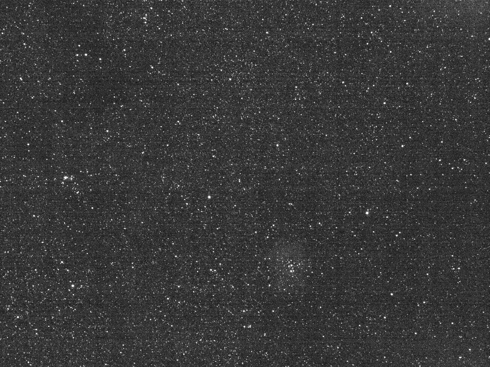 Grainy black-and-white view of stars filling the entire frame.