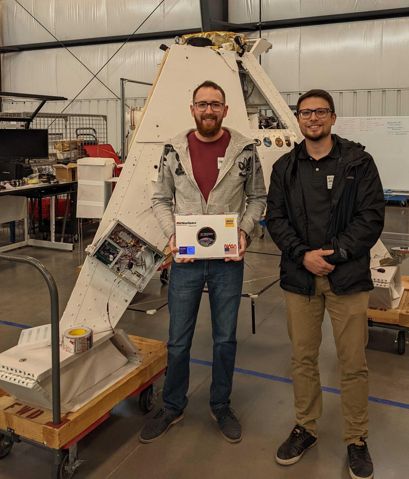 Arizona State University CubeSounder team members Kyle Massingill (left) and Michael Baricuatro with their weather sensor payload integrated onto the World View balloon hardware.