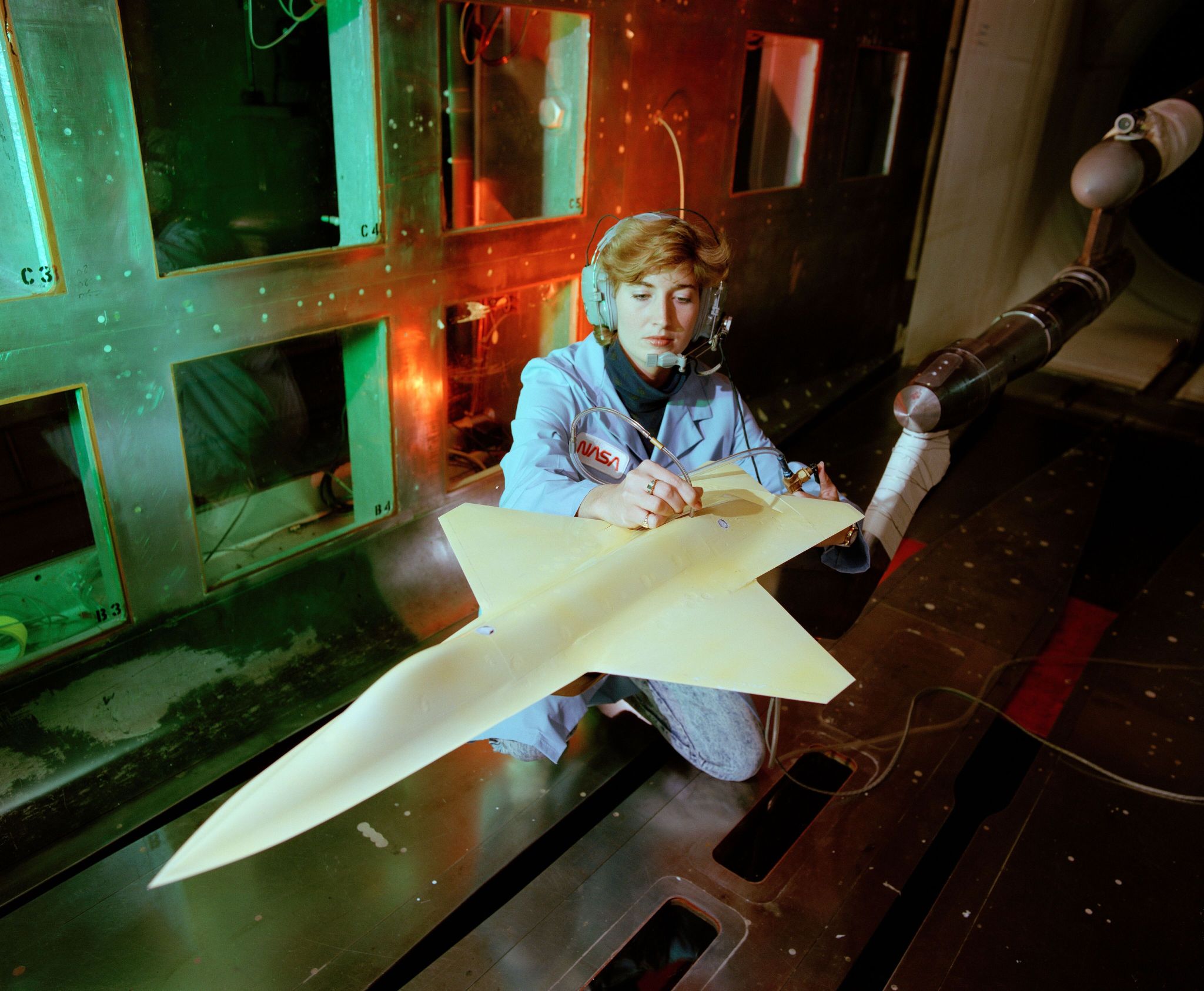 NASA technician Jody Chandler prepares an aircraft model, provided by McDonnell-Douglas Aerospace, for high-speed wind tunnel testing in the 8-Foot Transonic Pressure Tunnel.