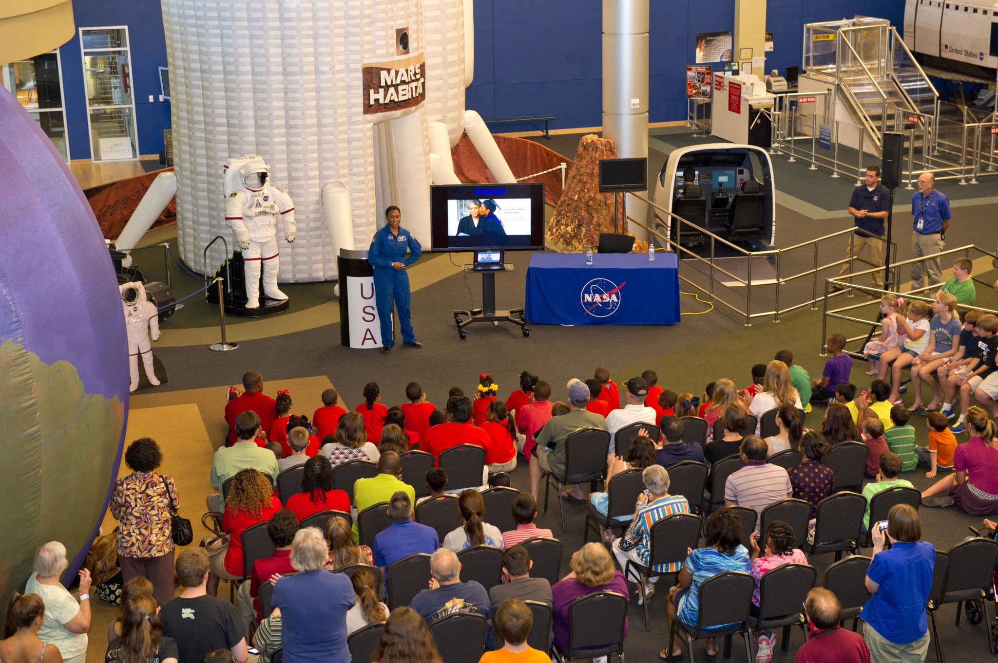 Astronaut Jeanette Epps speaks to visitors at INFINITY Science Center during a July 2014 event.