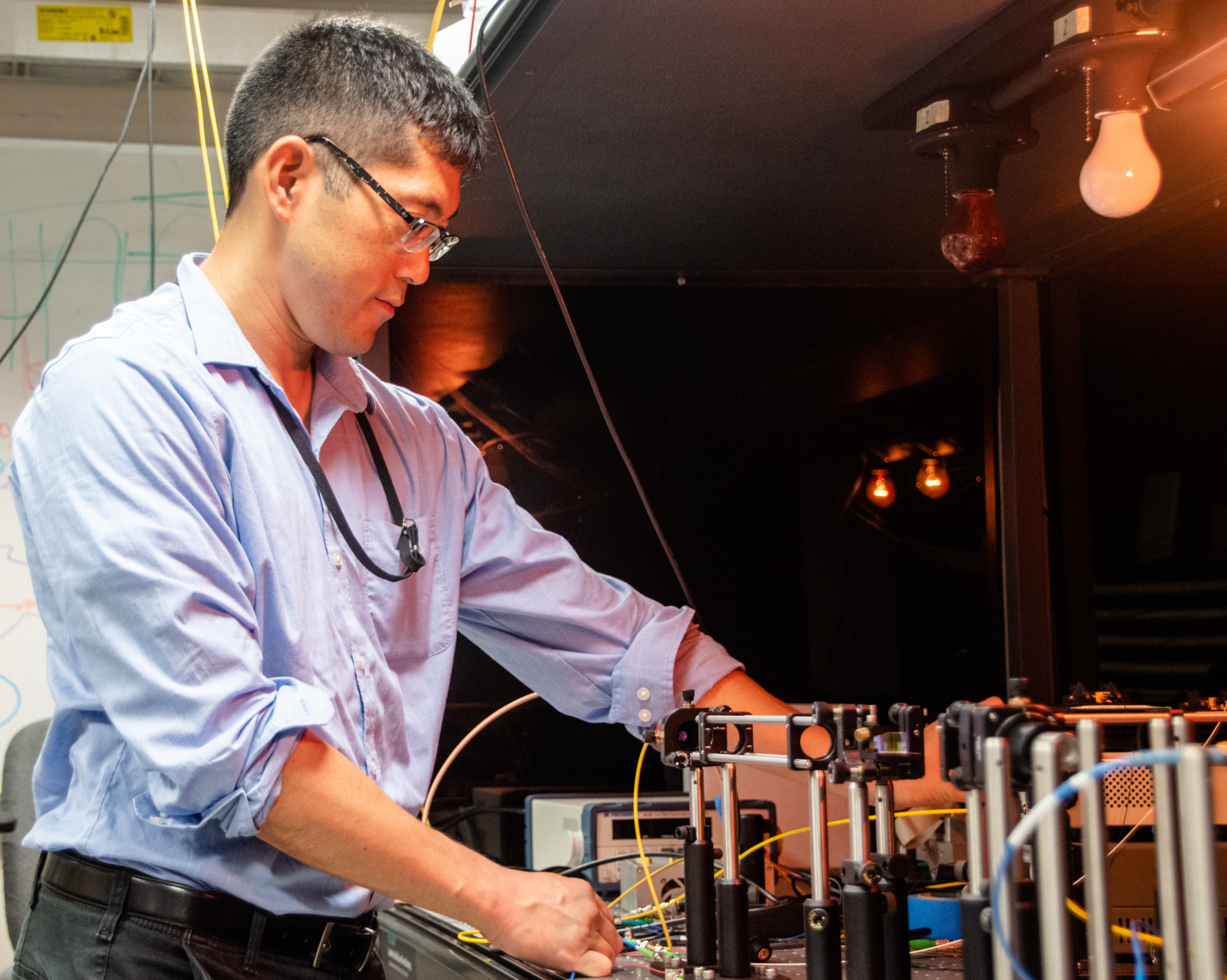 Space Communications and Navigation intern, Ryan Hashi, tests equipment in the Quantum Communications Lab at NASA’s Glenn Research Center.