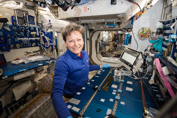 image of astronaut working with experiment