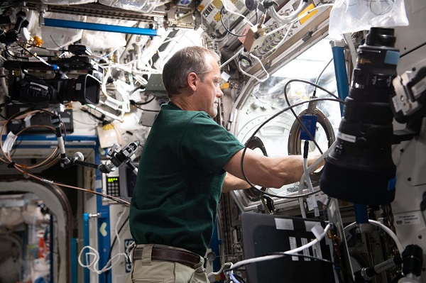 image of an astronaut working with an experiment