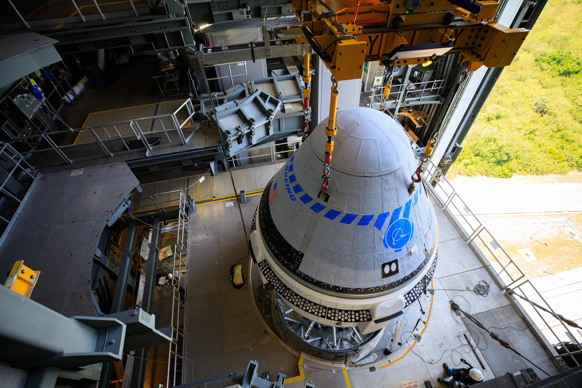 The Boeing CST-100 Starliner spacecraft is lifted at the Vertical Integration Facility at Space Launch Complex-41 at Florida's Cape Canaveral Space Force Station on May 4th, 2022.