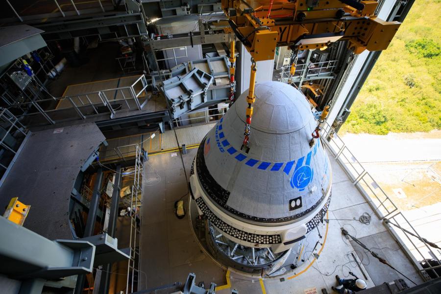 The Boeing CST-100 Starliner spacecraft is lifted at the Vertical Integration Facility at Space Launch Complex-41 at Florida's Cape Canaveral Space Force Station on May 4th, 2022.