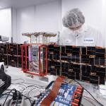 Here, a team member installs solar panels onto the CAPSTONE spacecraft – short for Cislunar Autonomous Positioning System Technology Operations and Navigation Experiment – before its launch to the Moon.