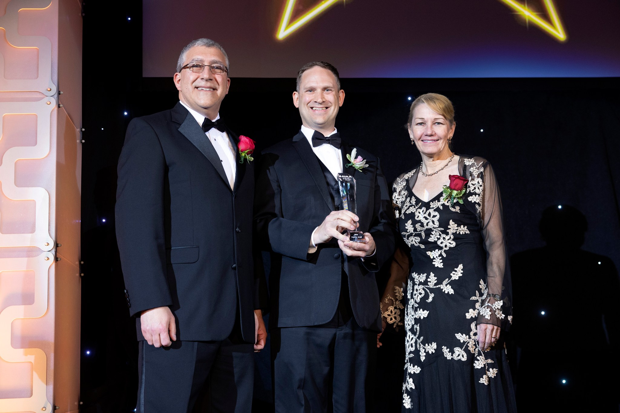 Paul Gradl, center, AIAA President Basil Hassan, left, and AIAA President-elect, Laura McGill, right, 