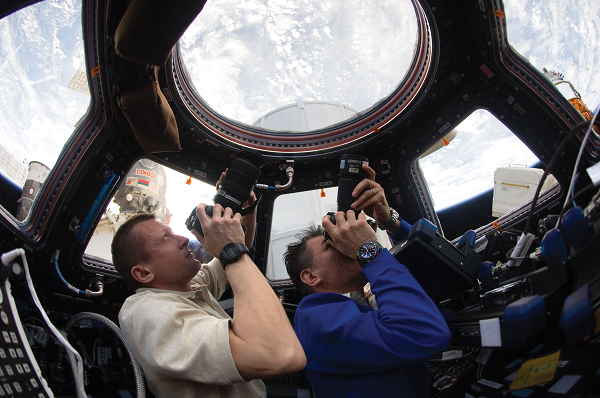 image of astronauts taking pictures of Earth