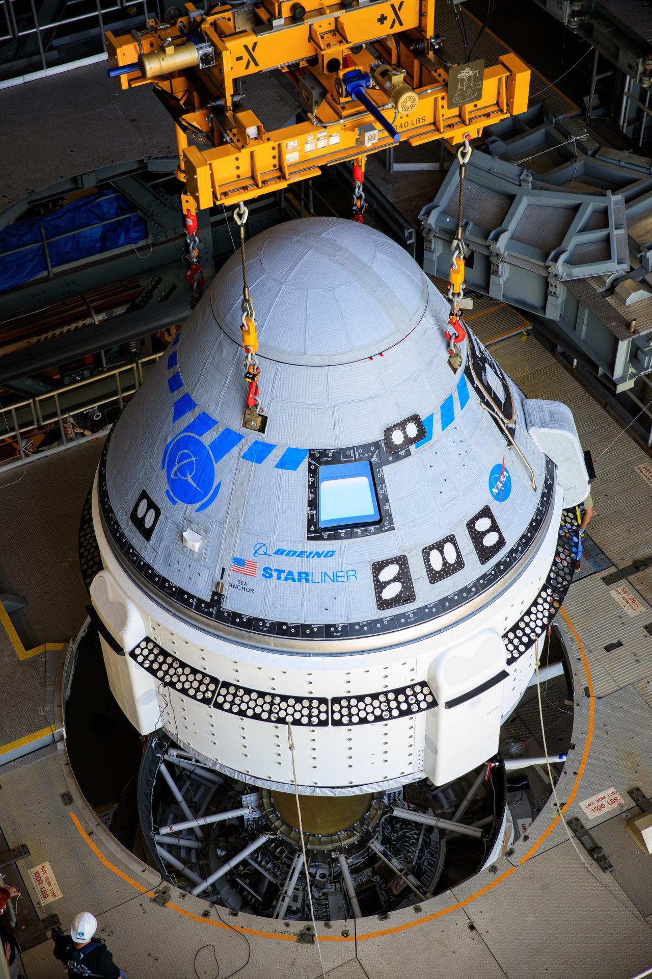 The Boeing CST-100 Starliner spacecraft is lifted at the Vertical Integration Facility at Space Launch Complex-41 at Florida's Cape Canaveral Space Force Station on May 4, 2022.