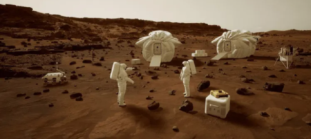 Two astronauts on the surface of Mars at a basecamp. Two habitats and some equipment is seen strewn about the camp.