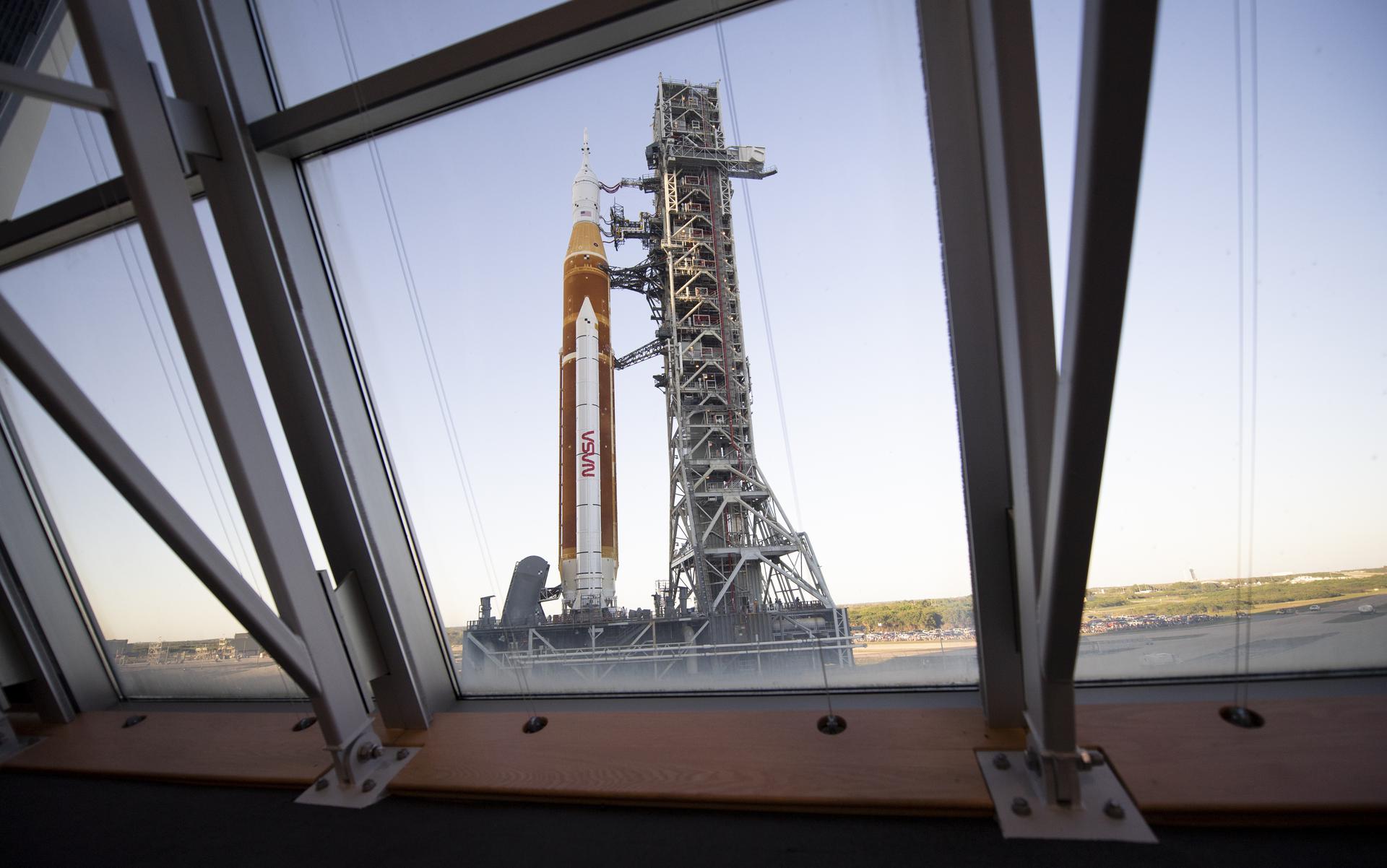NASA’s Space Launch System (SLS) rocket with the Orion spacecraft aboard is seen through the windows of Firing Room One in the Rocco A. Petrone Launch Control Center at NASA’s Kennedy Space Center in Florida.