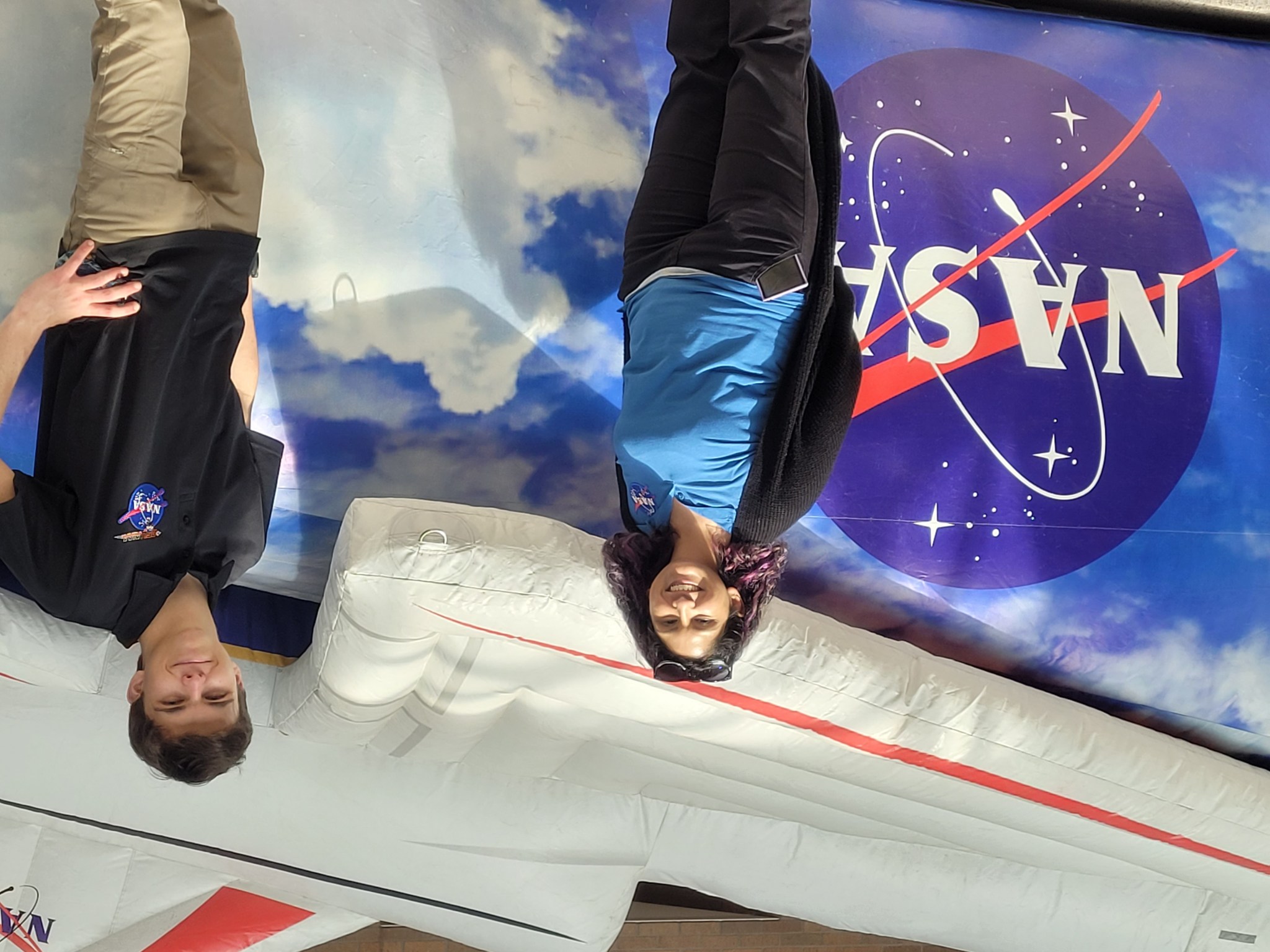 NASA interns Holly Garza, left, and Liam Brinton are pictured in front of the inflatable X-59.