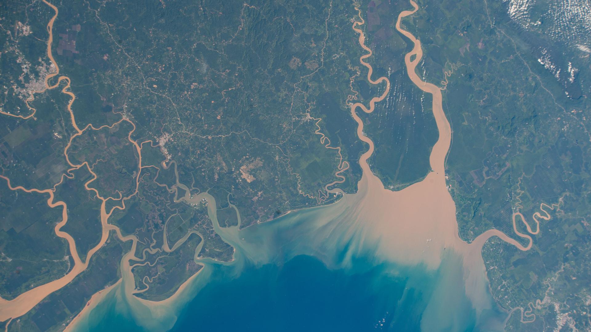 image of rivers flowing out to a coast around a peninsula