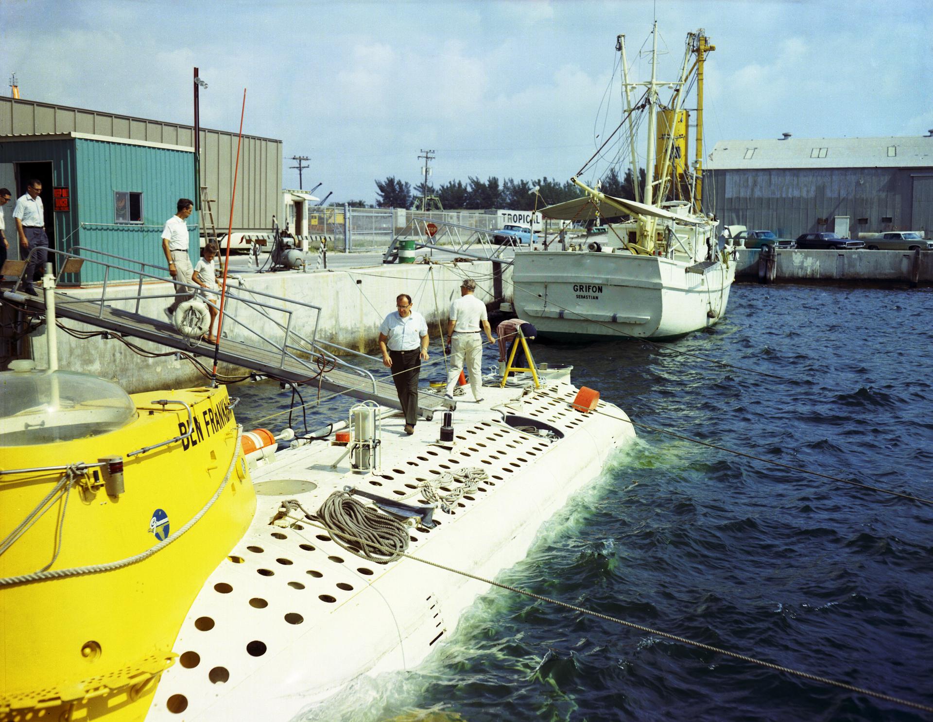 NASA officials survey the deep-sea research submarine Ben Franklin while docked in July 1969. 