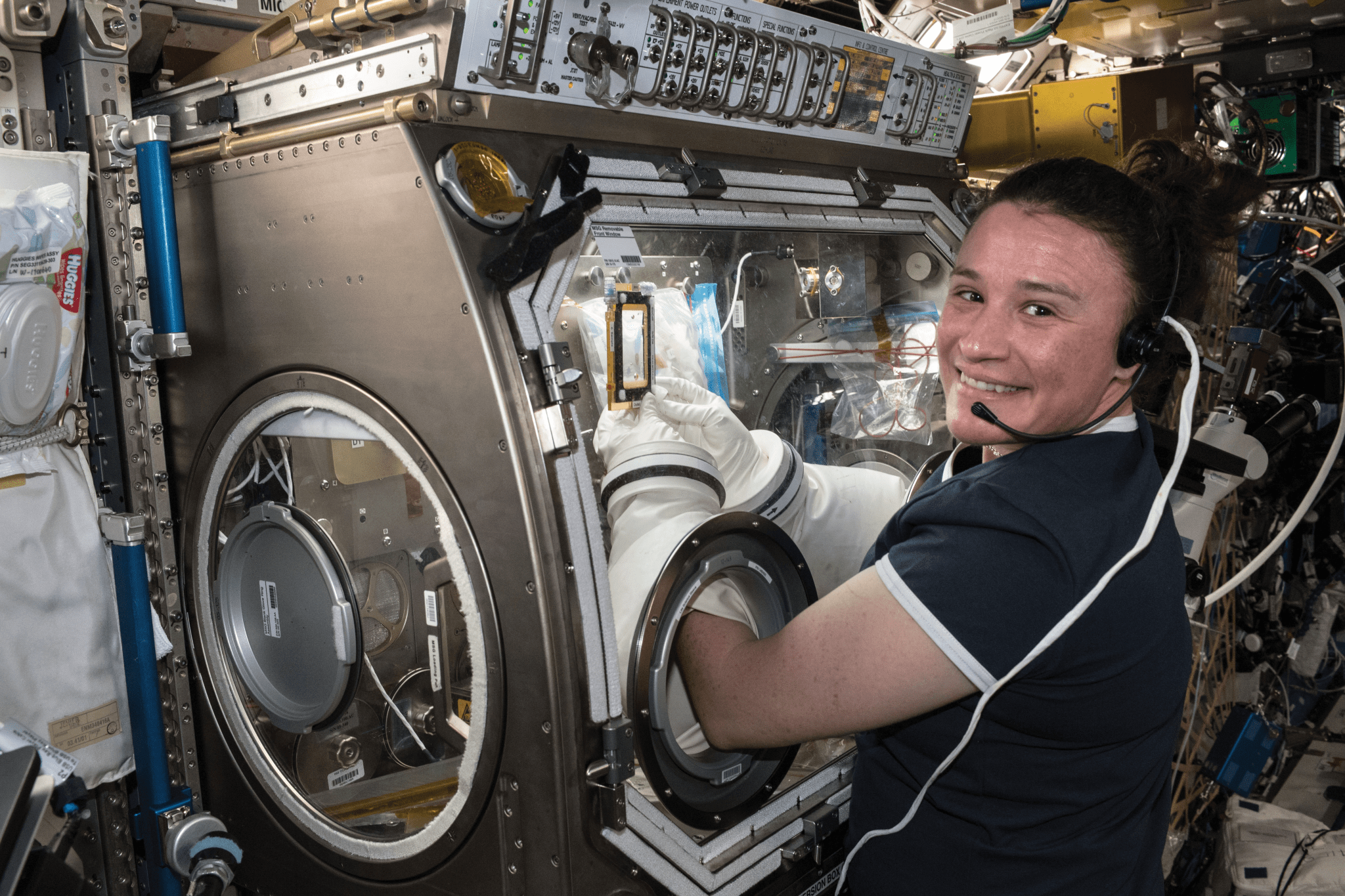 image of an astronaut working at a science glovebox