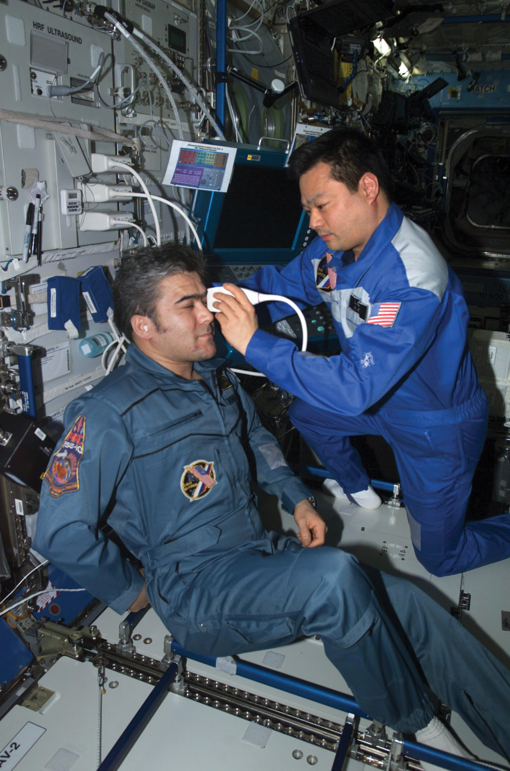 image of an astronaut doing an ultrasound on another astronaut