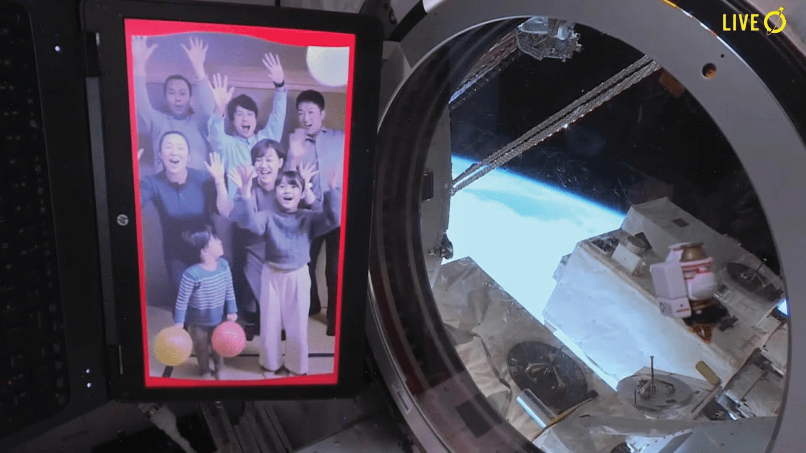 image of a family portrait shown in a tablet inside the space station