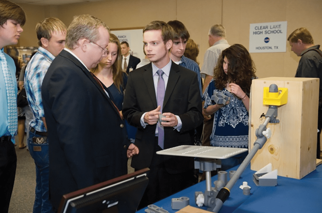 image of students presenting their project to judges