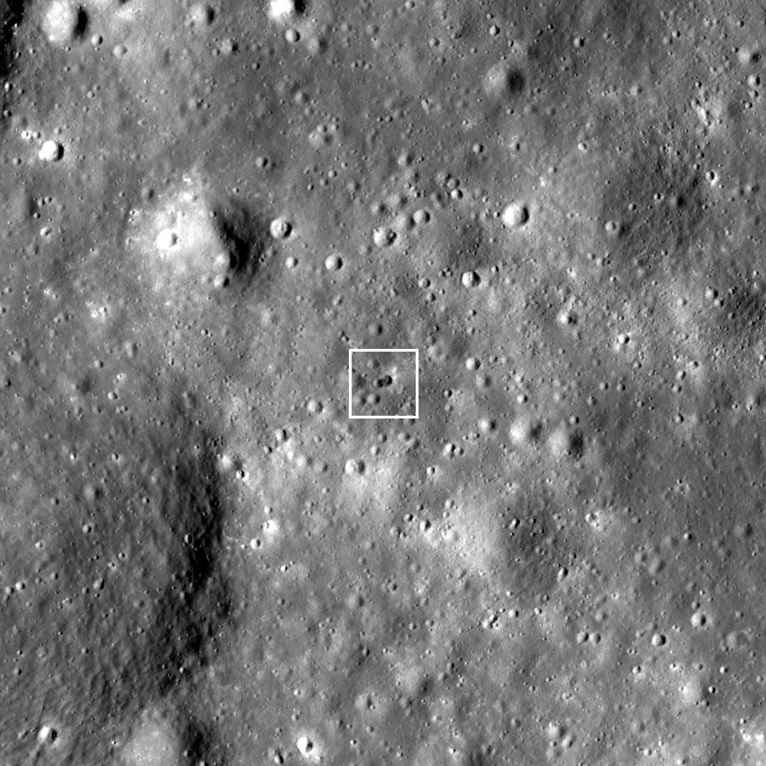 rocky, grayscale lunar landscape, as seen from above by LRO; a white square outline indicates the rocket body impact site