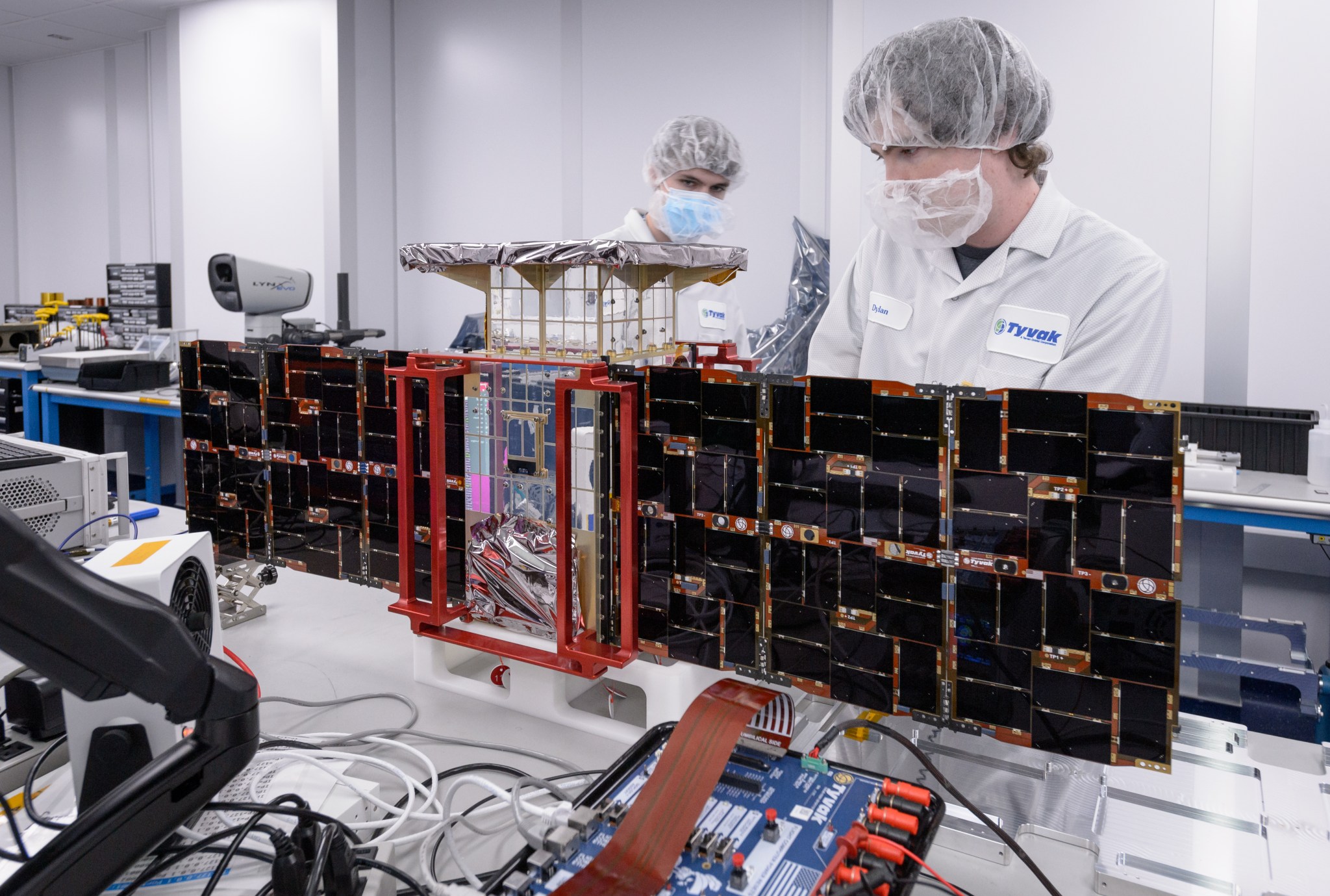 Team members install solar panels onto the CAPSTONE spacecraft – short for Cislunar Autonomous Positioning System Technology Operations and Navigation Experiment – at Tyvak Nano-Satellite Systems Inc. in Irvine, California.