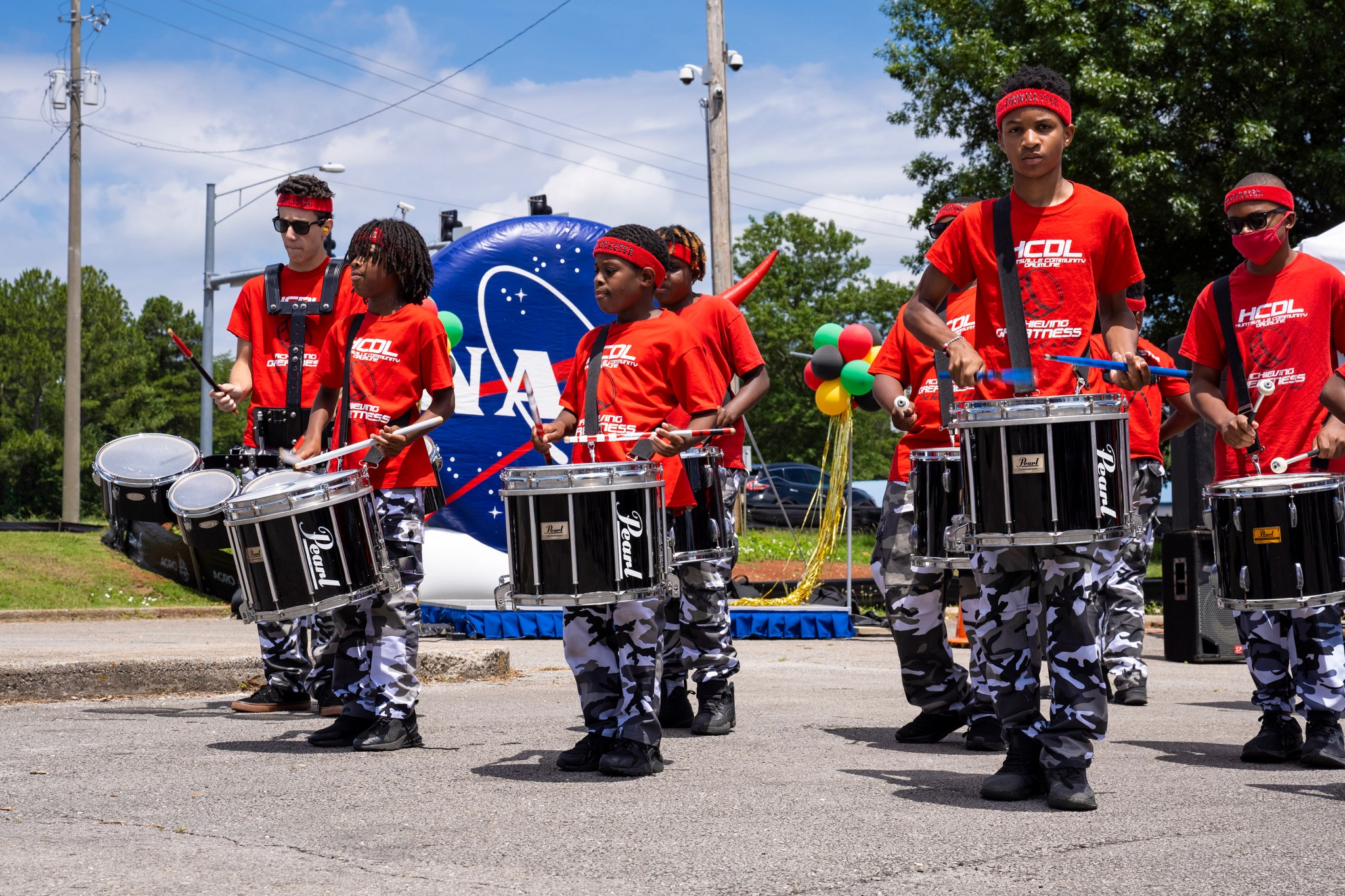Members of the Huntsville Community Drumline add a festive beat to Marshall’s Juneteenth festival. 