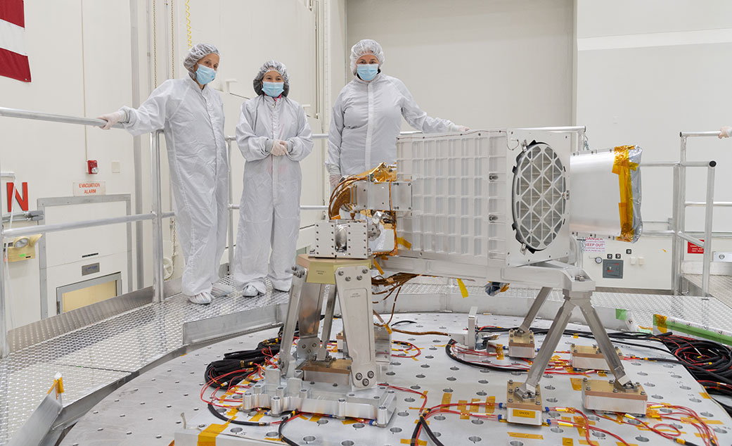 Officials from NASA and JPL oversee vibration testing of the EMIT science instrument