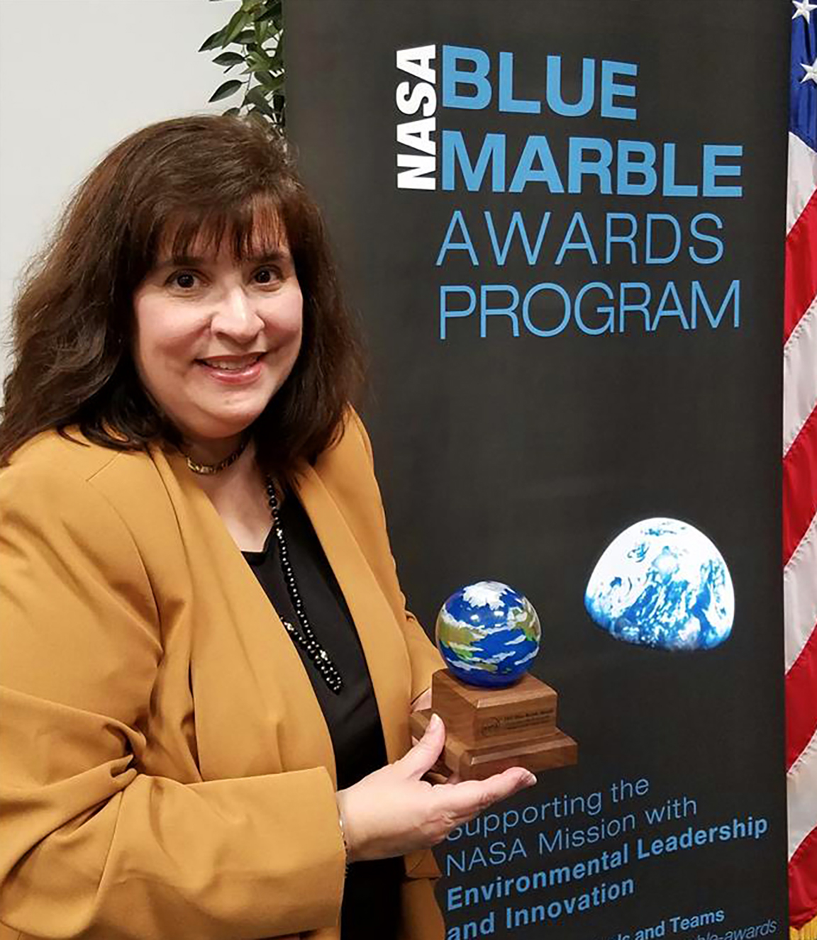Gaudy Bezos-OConnor is holding her Blue Marble award.
