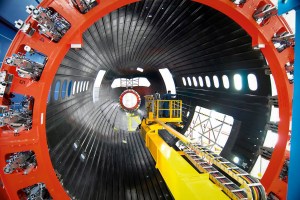 The forward section of a Boeing 787 Dreamliner is shown under construction inside a composite fabrication tool.