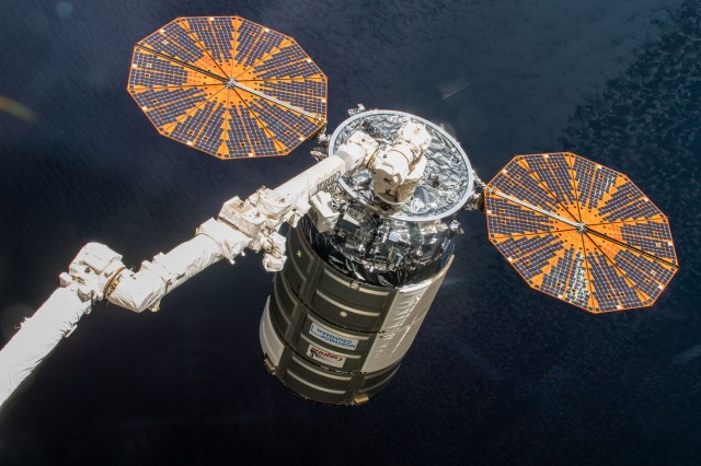 Cygnus space freighter in the grips of the Canadarm2 robotic arm