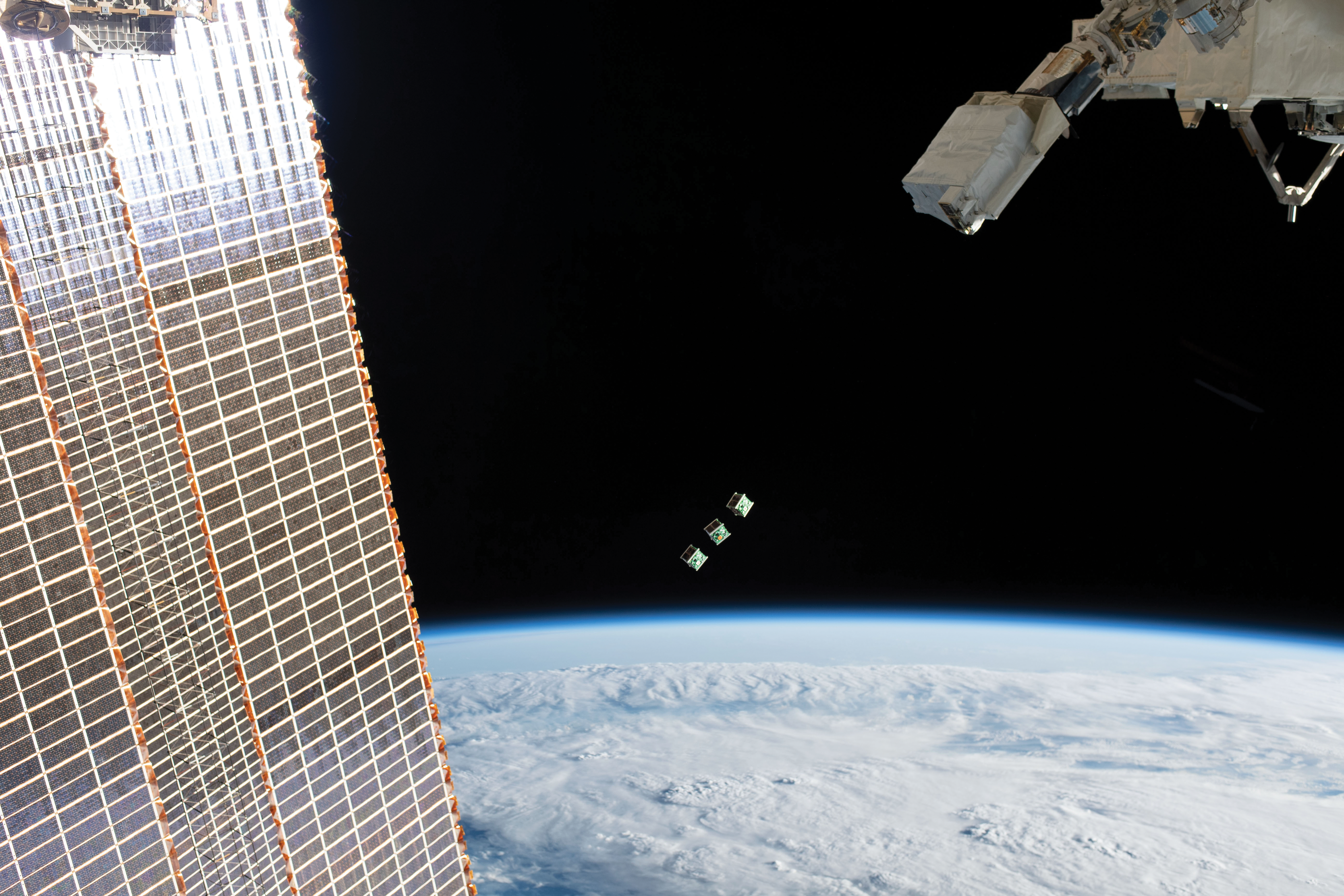 image of cubesats being deployed from the space station