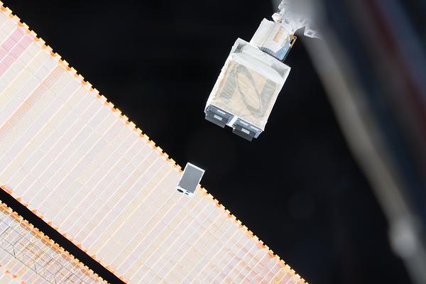 image of a cubesat being deployed from the space station