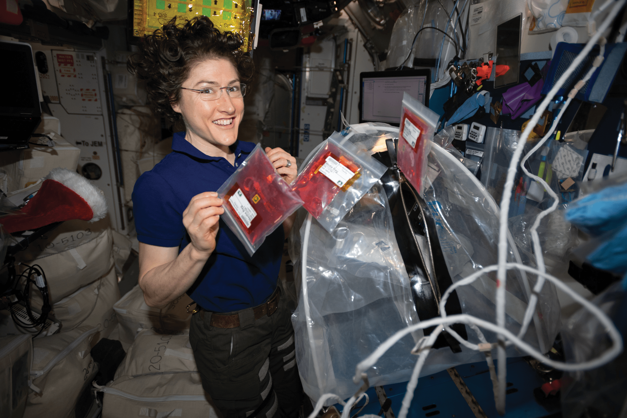 image of astronaut holding up experiment samples