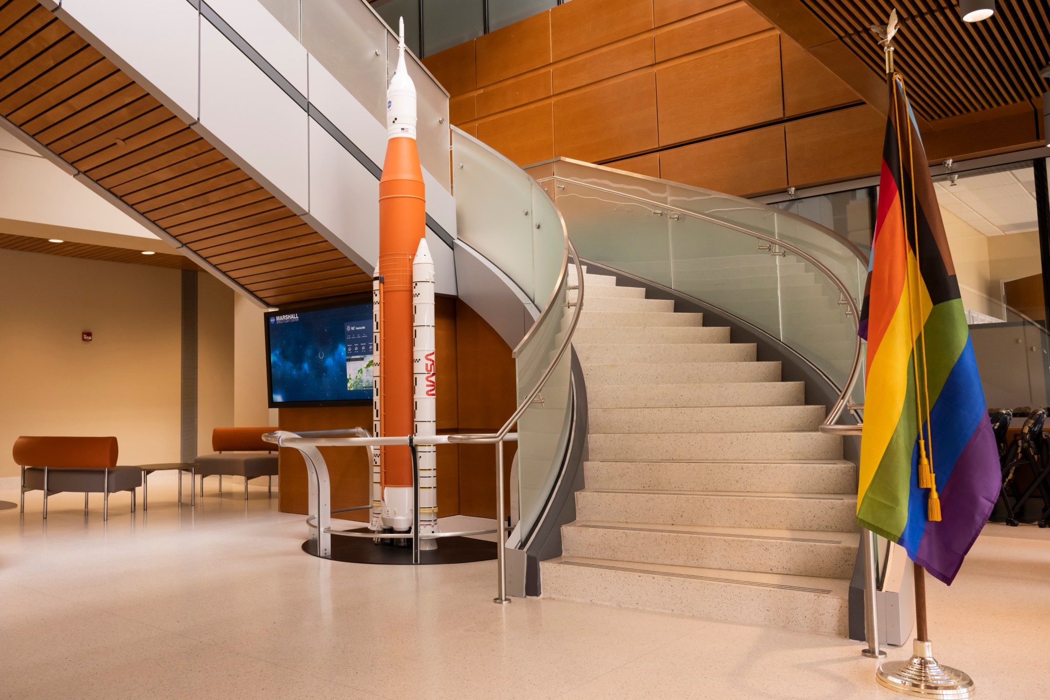 Marshall displays a Pride Month flag in Building 4221, alongside a model of the Space Launch System, NASA’s new rocket bound for the Moon. 