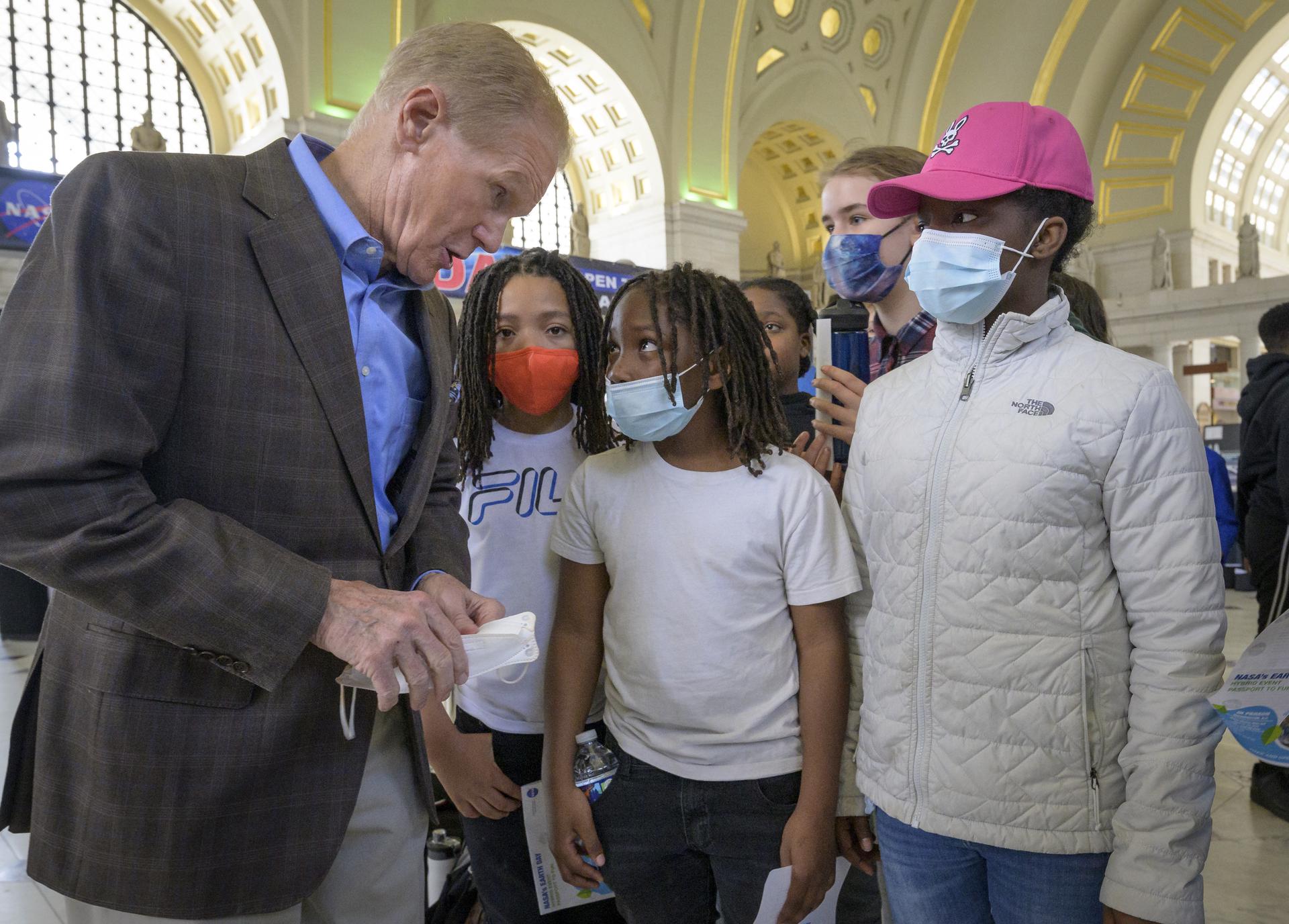 NASA Administrator Bill Nelson, left, talks with Washington area school children about Earth Day during his visit of NASA hands-on exhibits inside Union Station in Washington, Friday, April 22, 2022.