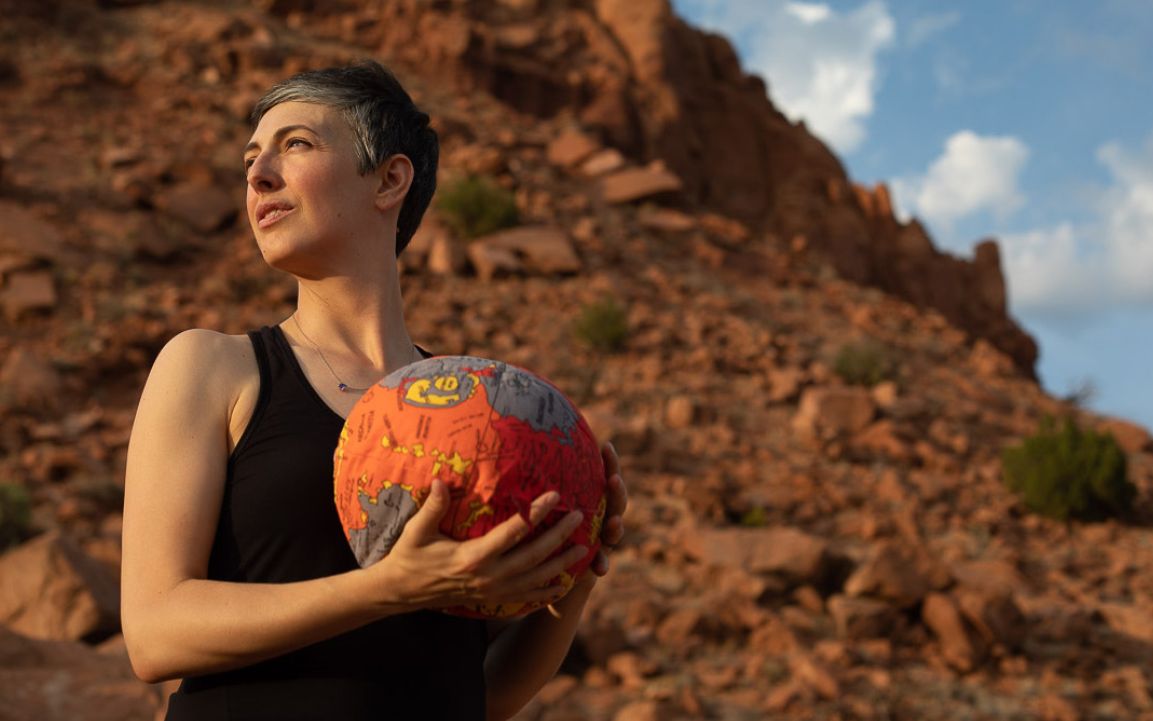 Nina Lanza, the principal investigator for the Perseverance rover's SuperCam instrument, holds a model of Mars in Abiquiu, New Mexico.