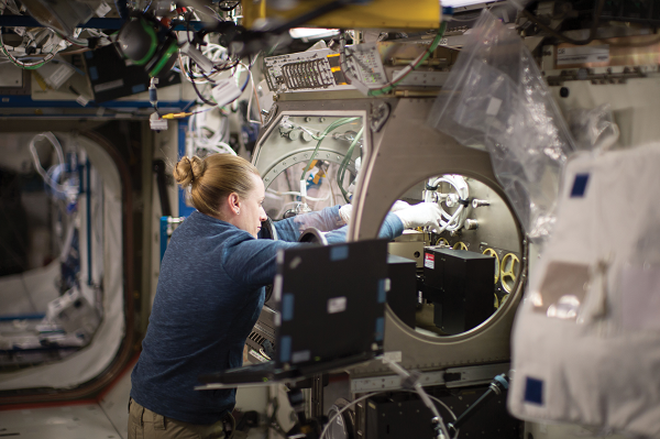 image of an astronaut working with an experiment