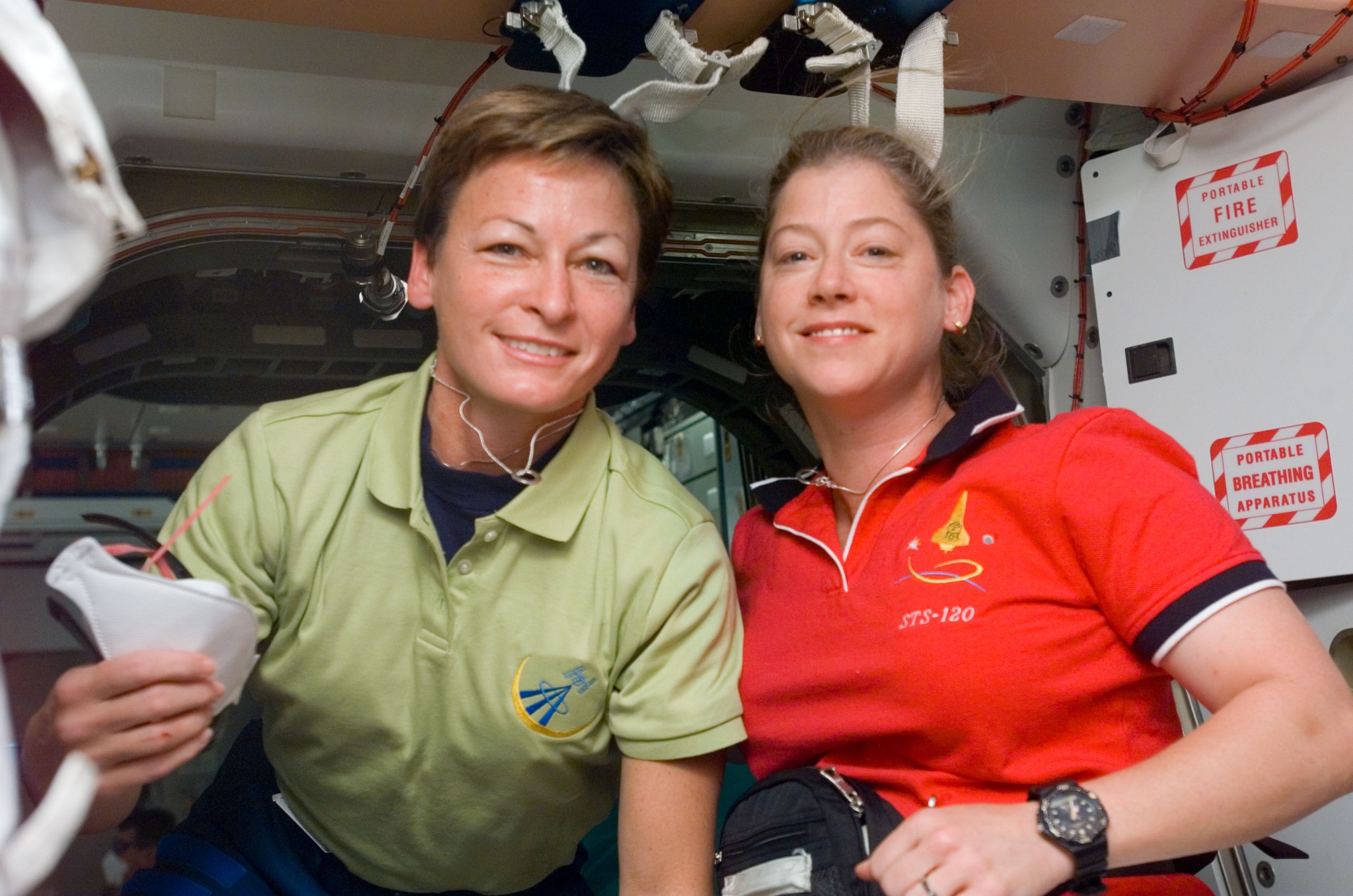 Astronaut Peggy A. Whitson (left), Expedition 16 commander, and Pam Melroy, STS-120 commander