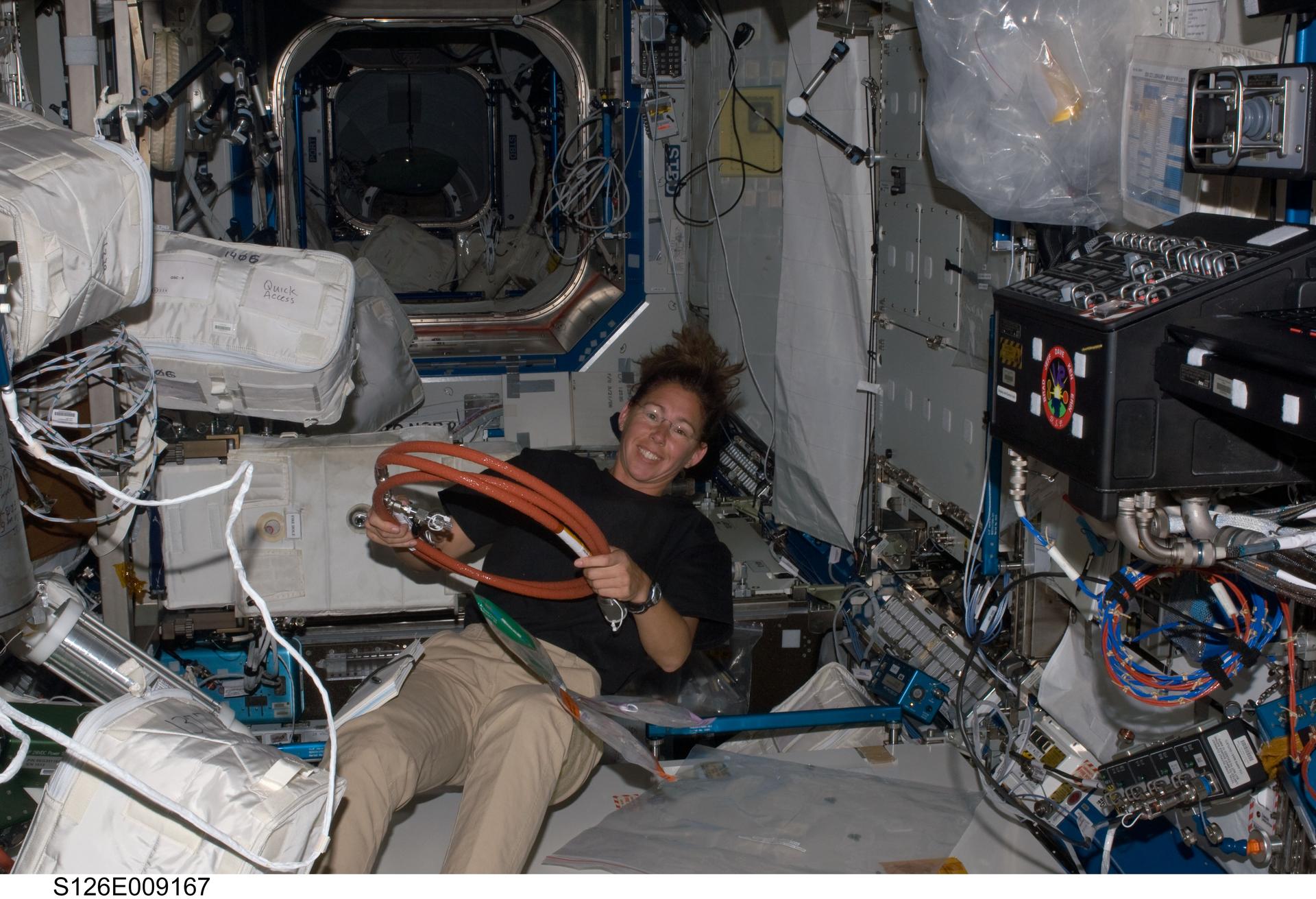 NASA astronaut Sandra Magnus, Expedition 18 flight engineer, works in the Destiny laboratory of the International Space Station in November 2008, while Space Shuttle Endeavour (STS-126) remains docked with the station.