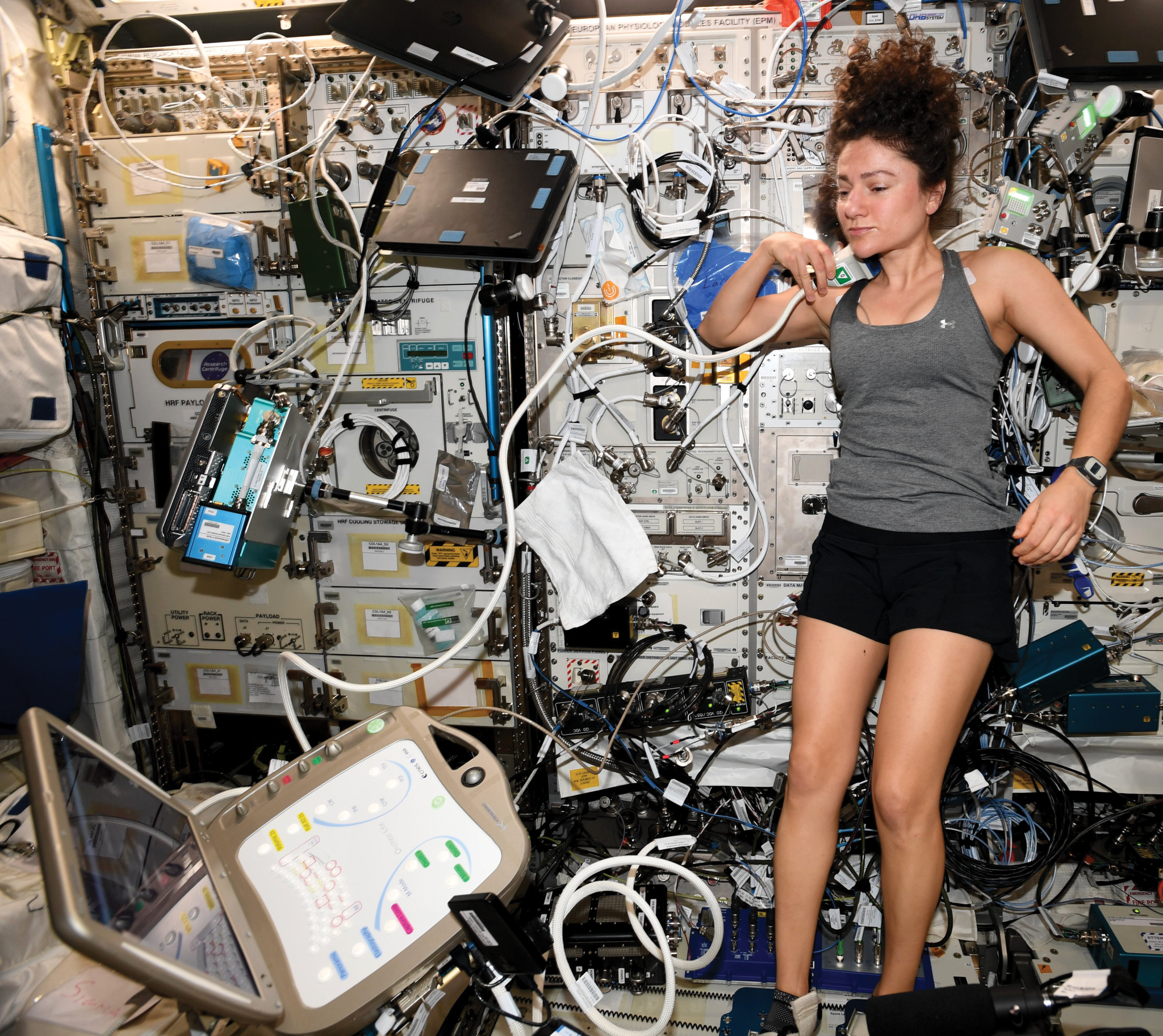 image of an astronaut conducting an ultrasound on herself