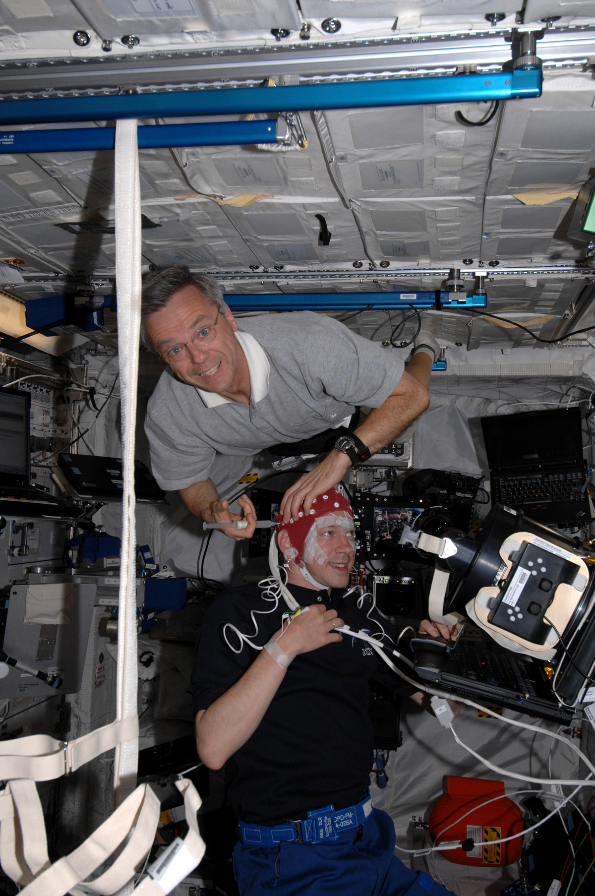 image of two astronauts working on an experiment