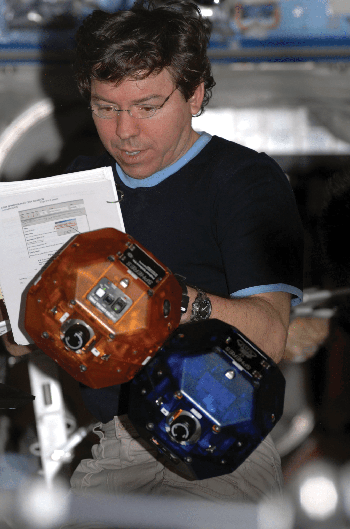 image of an astronaut working with flying robots