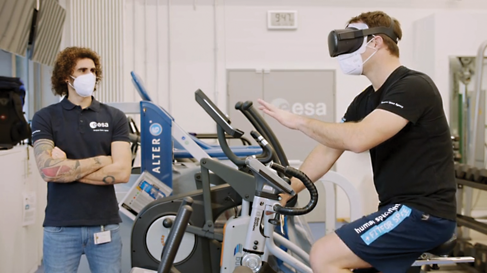 image of an astronaut riding a stationary bike wearing VR goggles