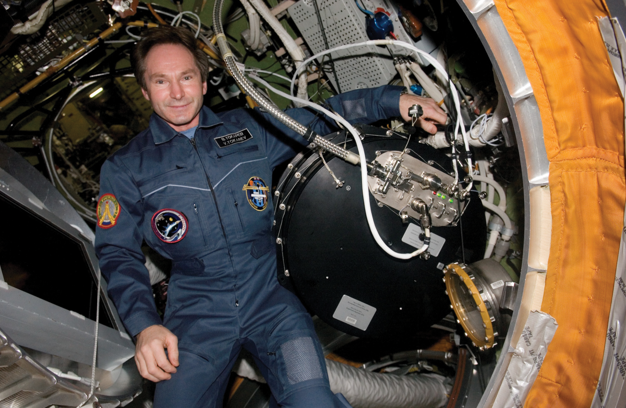 image of an astronaut next to hardware in the station module 