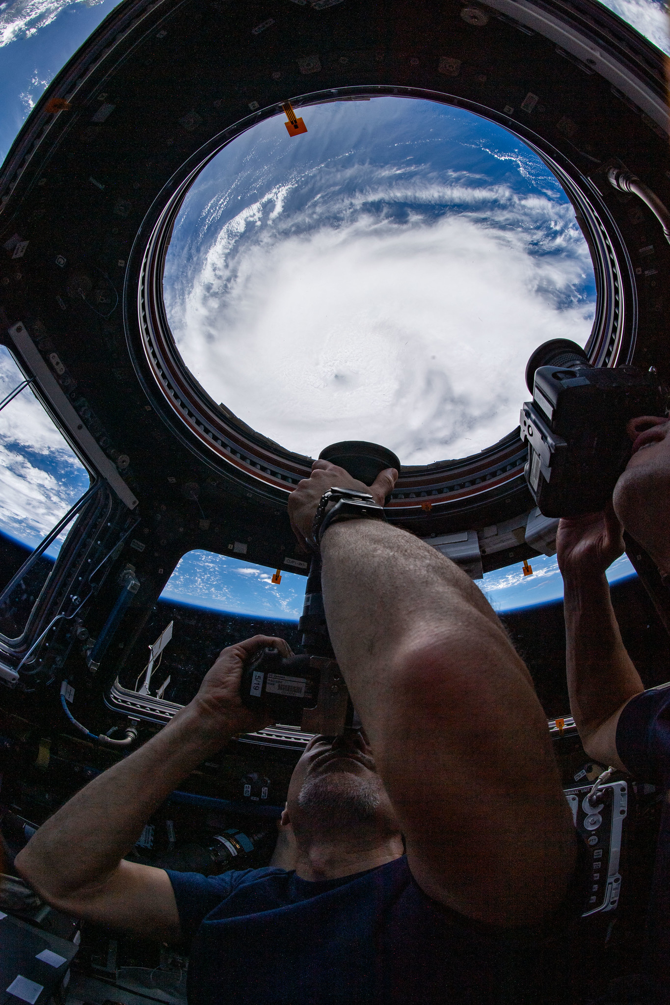 image of astronauts taking pictures of a hurricane