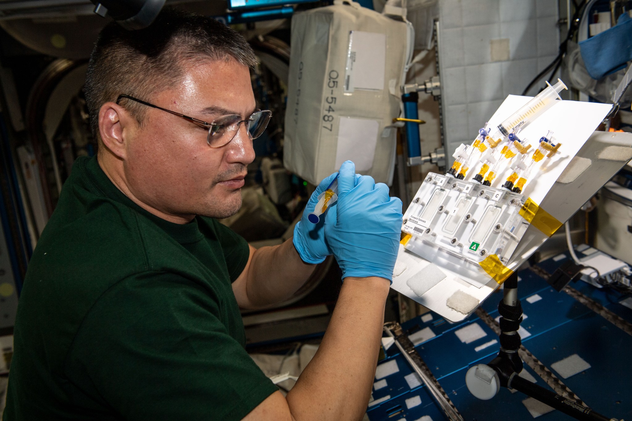 image of an astronaut working with an experiment