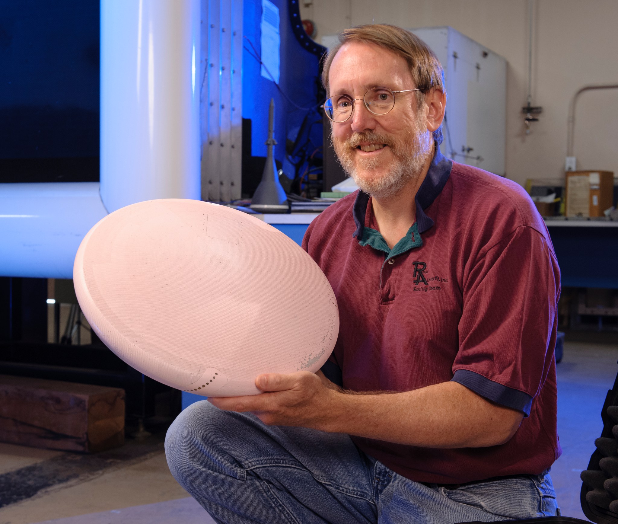 Jim Ross holding a model of the Orion heat shield 