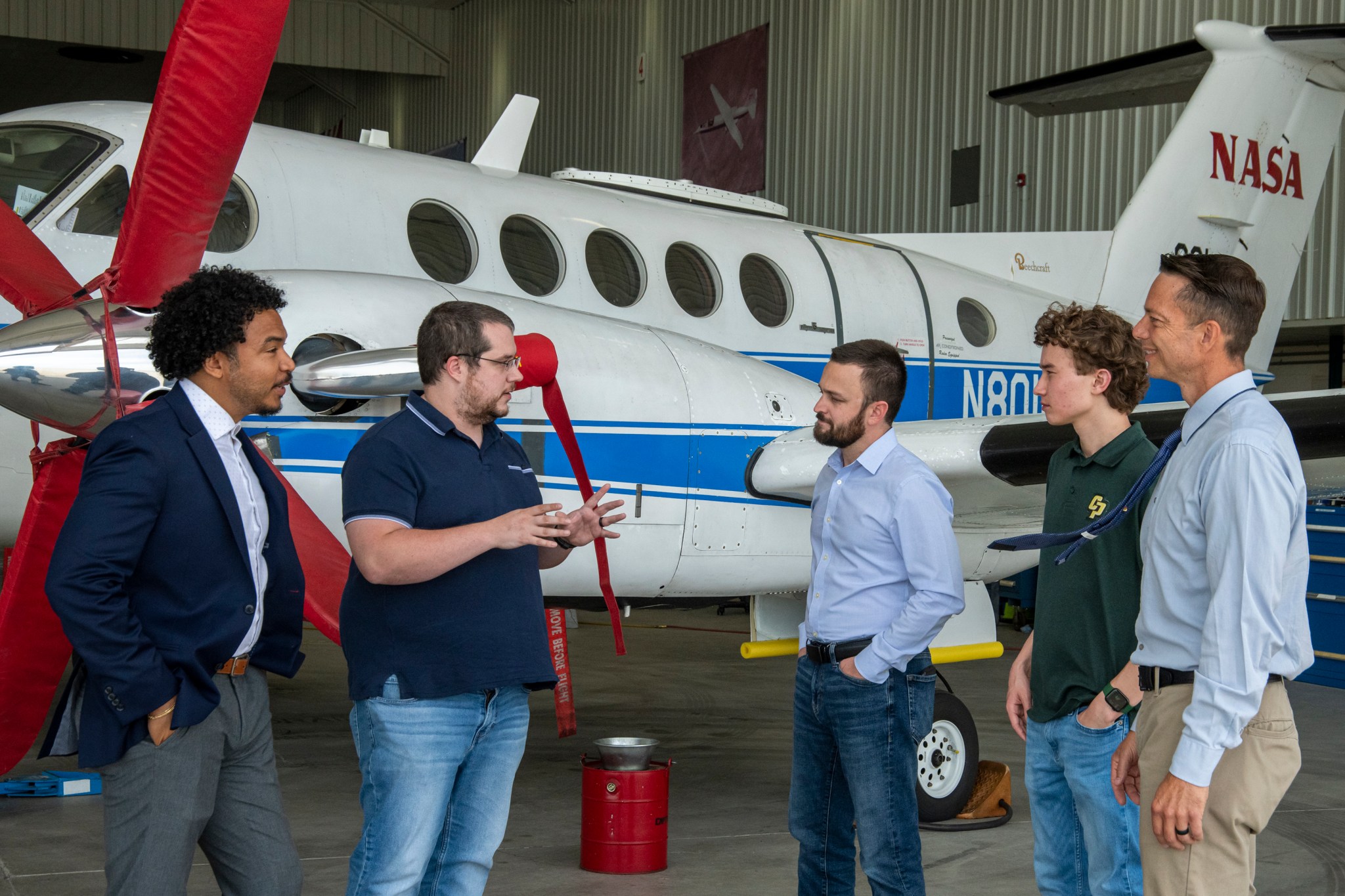 Matthew Walderson, second left, is principal investigator for a wireless hub designed to more easily update aircraft electronics. Pictured (L to R) are Terrence Garry, Brian Boogaad, NASA intern Jack Young, and Technology Transfer Officer Ben Tomlinson.