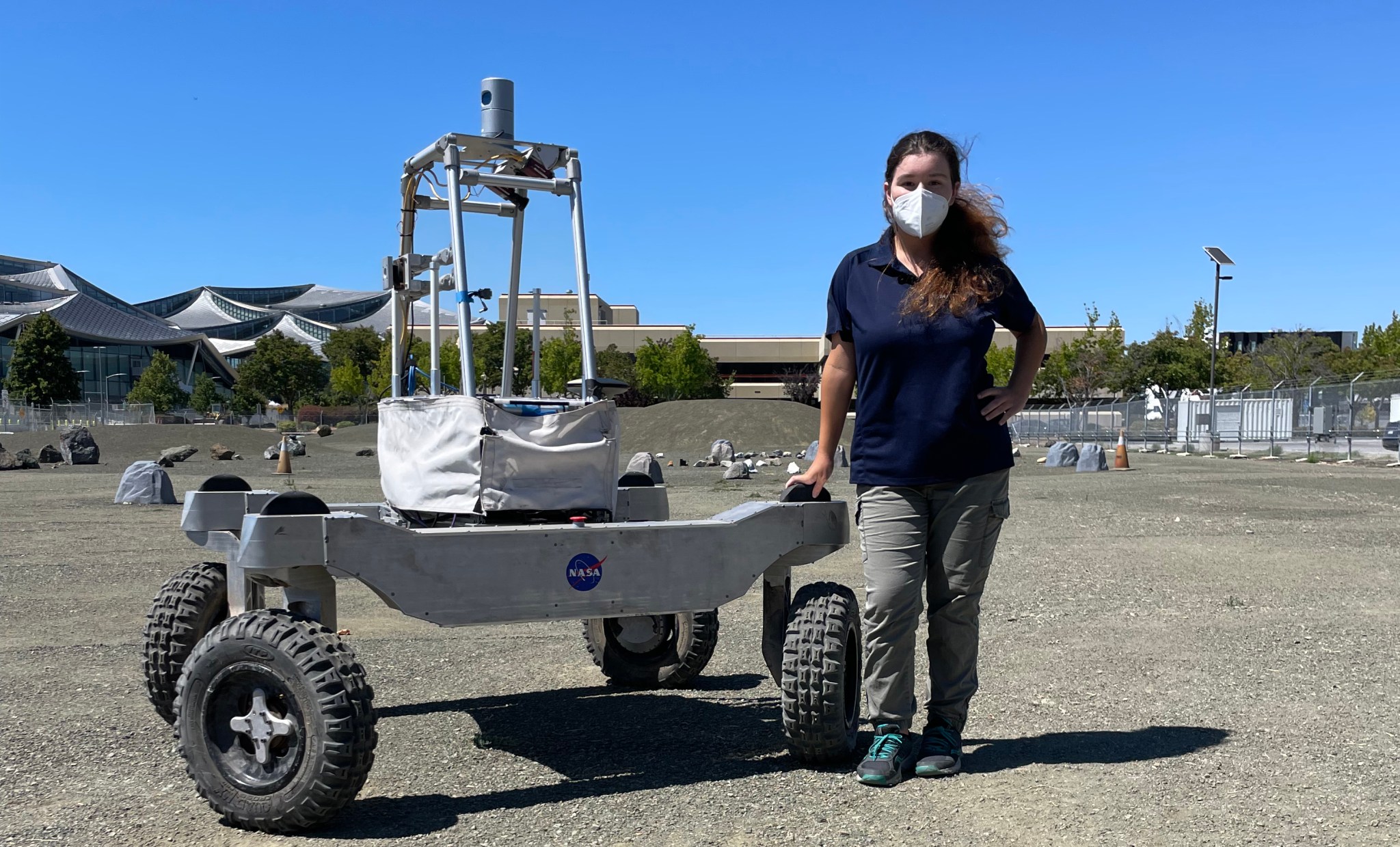 Anna standing next to robot.